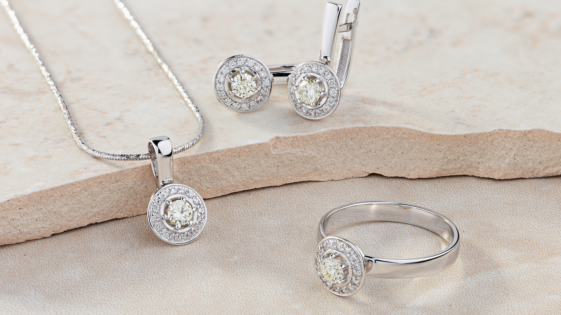 Elegant jewelry set of white gold ring, necklace and earrings with diamonds